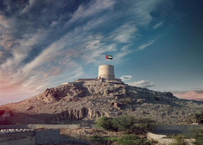 Majestic view of the Hatta Tower under a scenic sky, highlighting UAE's heritage.