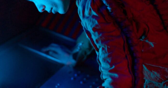 A female astronaut operates a control panel in a sci-fi spaceship with blue lighting.